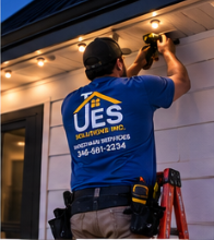 UES Solutions installer mounting permanent LED track under the eave