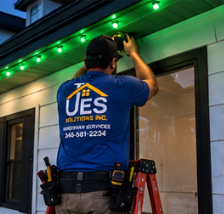UES Solutions installer mounting LED track showing green