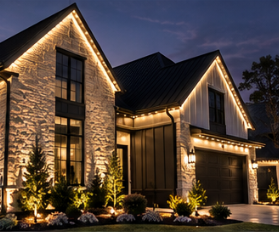 Warm white permanent roofline lighting on a stone and stucco home