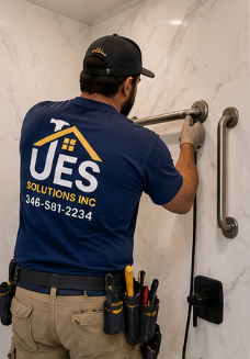 UES Solutions installer mounting a grab bar in a new walk-in shower